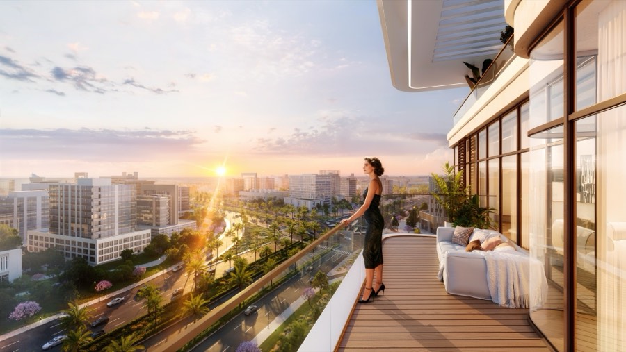 Resident on a Kaia balcony overlooking the gardens at sunset