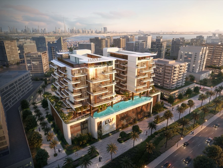 Aerial view of Kaia Residences at sunset with the pool deck and Dubai skyline