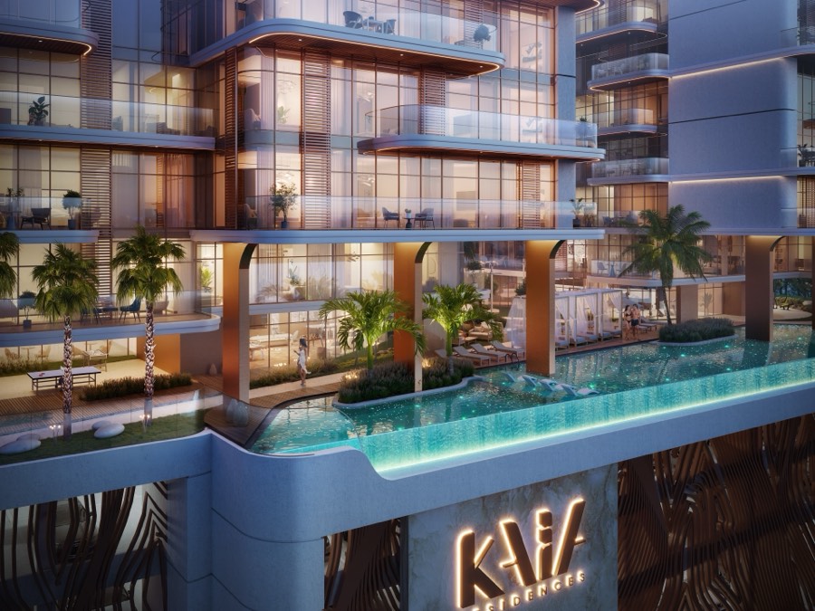The crystal infinity pool and illuminated facade at dusk